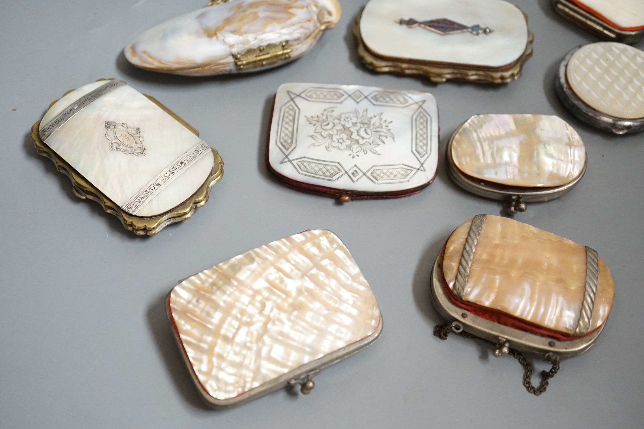 Twelve 19th century mother of pearl purses and containers